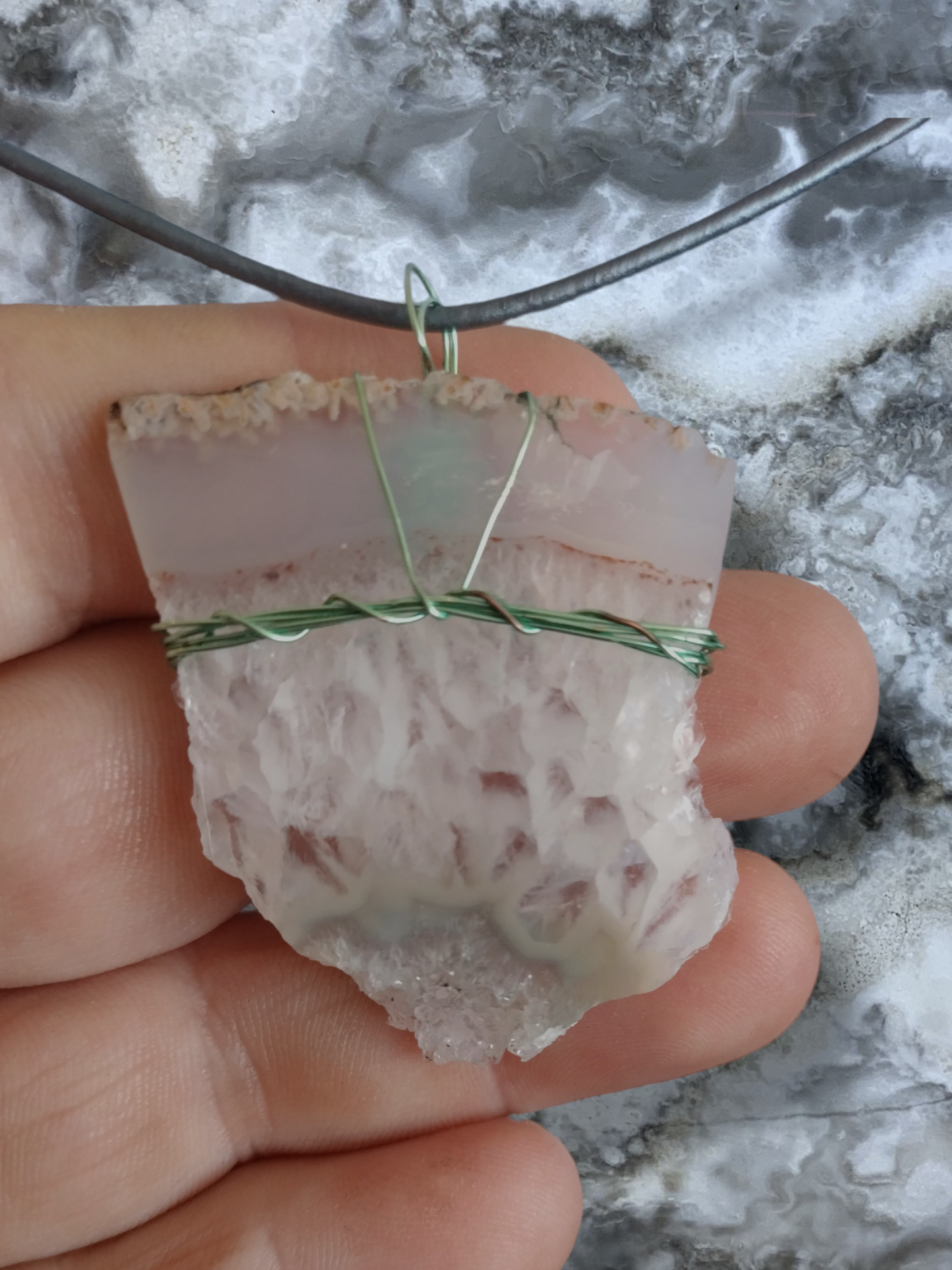 Agate piece handwrapped pendant on an adjustable leather cord.