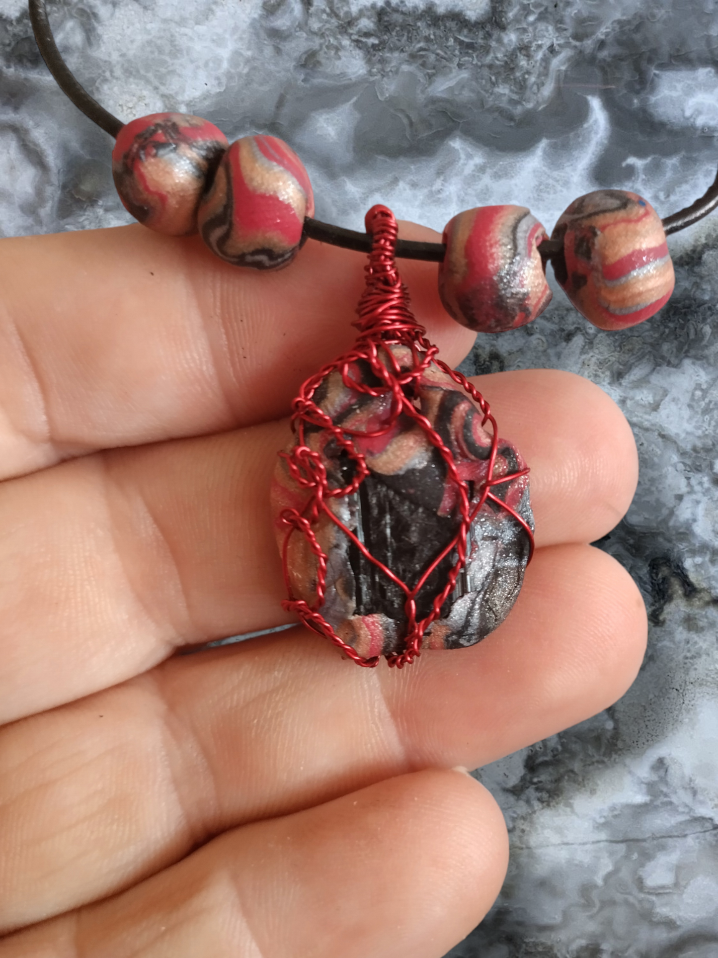 Black tourmaline in a clay pendant on an adjustable leather cord necklace.