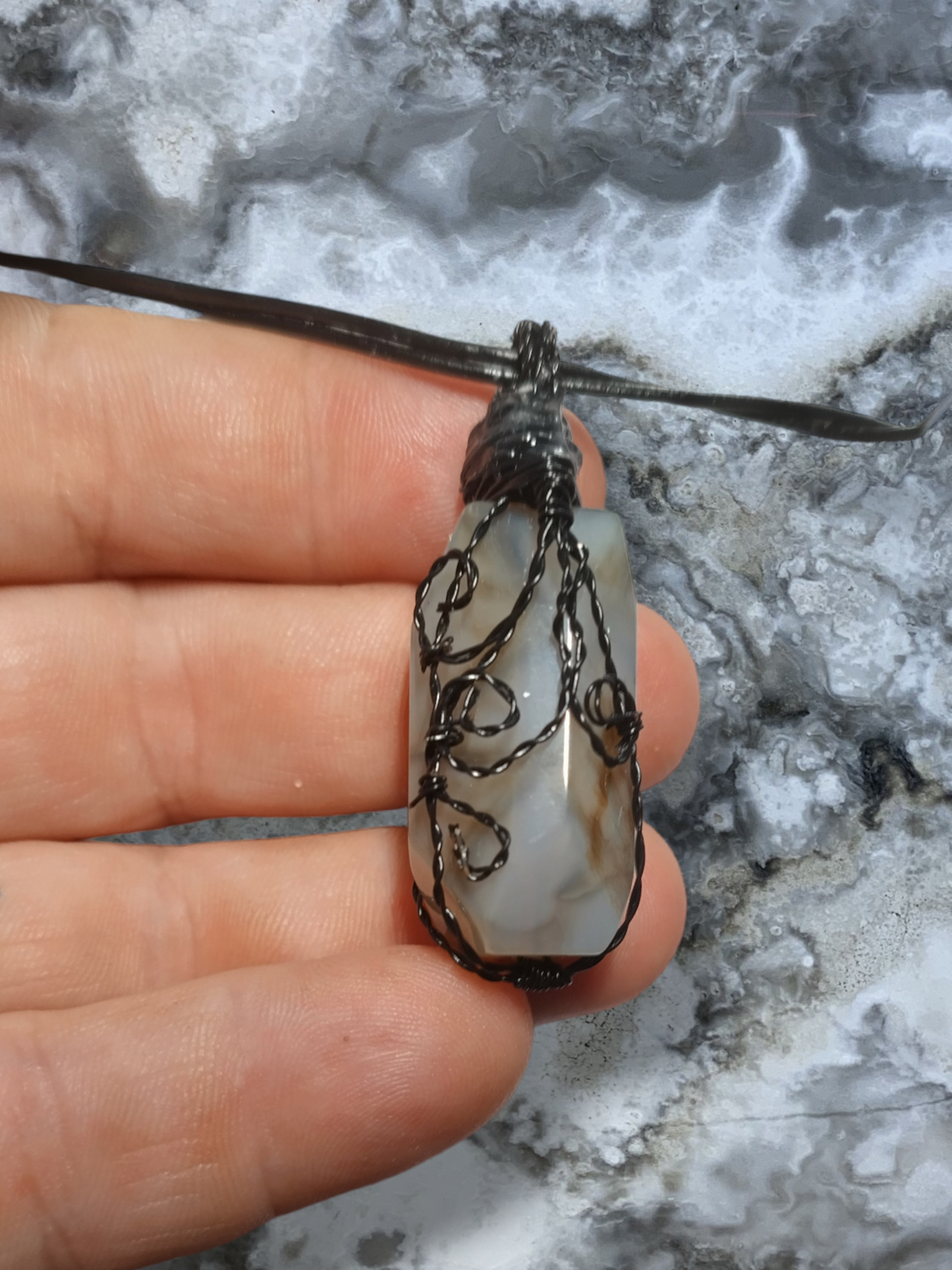 Agate hand wrapped pendant on an adjustable leather cord necklace.