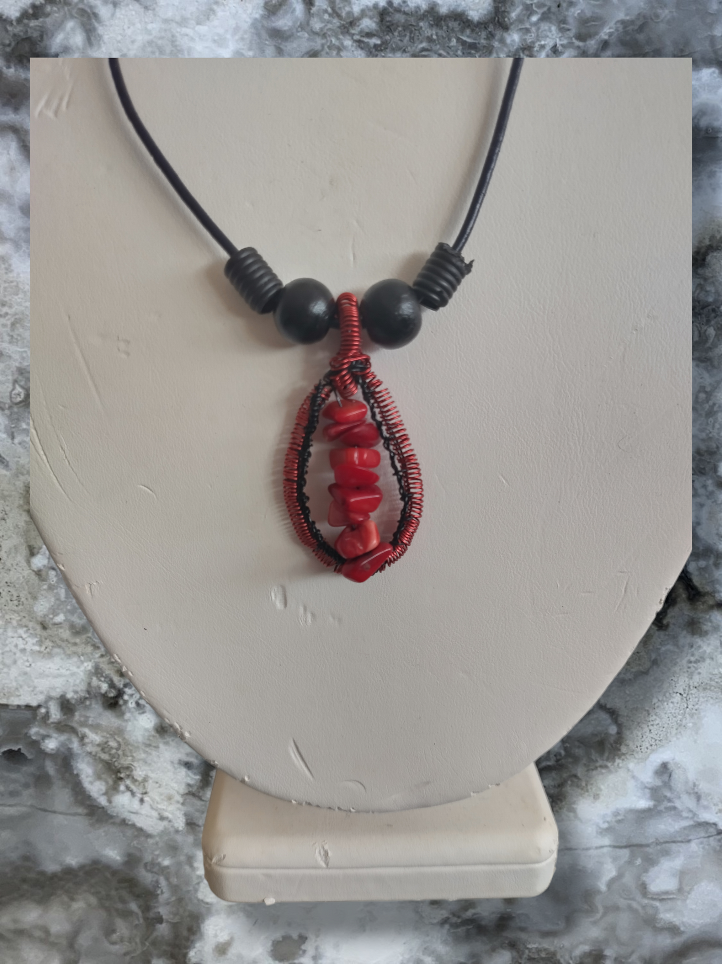 Dyed red coral pendant on an adjustable leather cord.