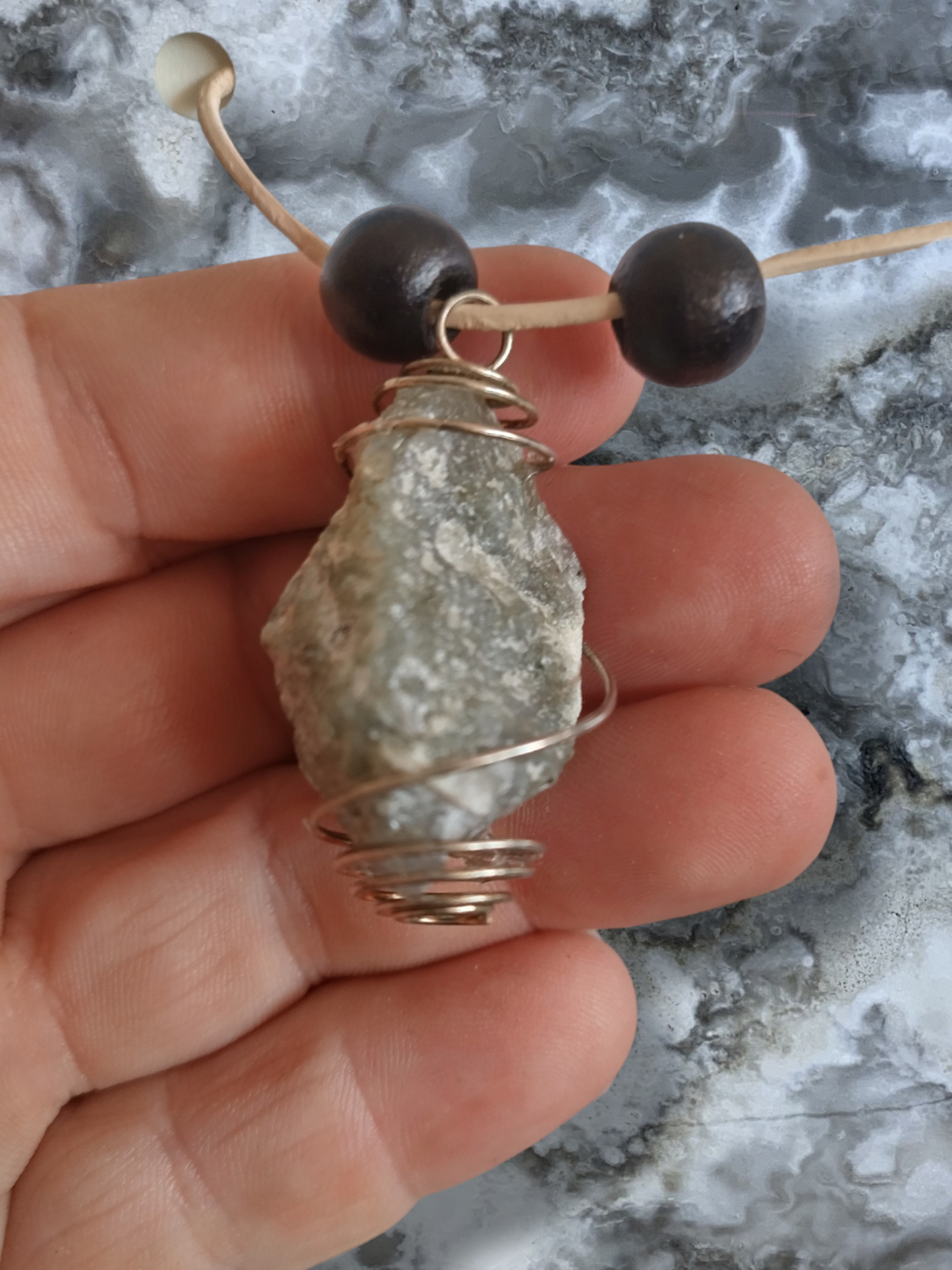 Rough labradorite hand wrapper pendant on an adjustable leather cord.