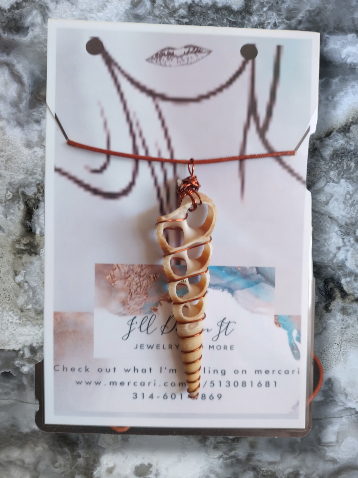 Shell hand wrapped pendant on an adjustable leather cord necklace.