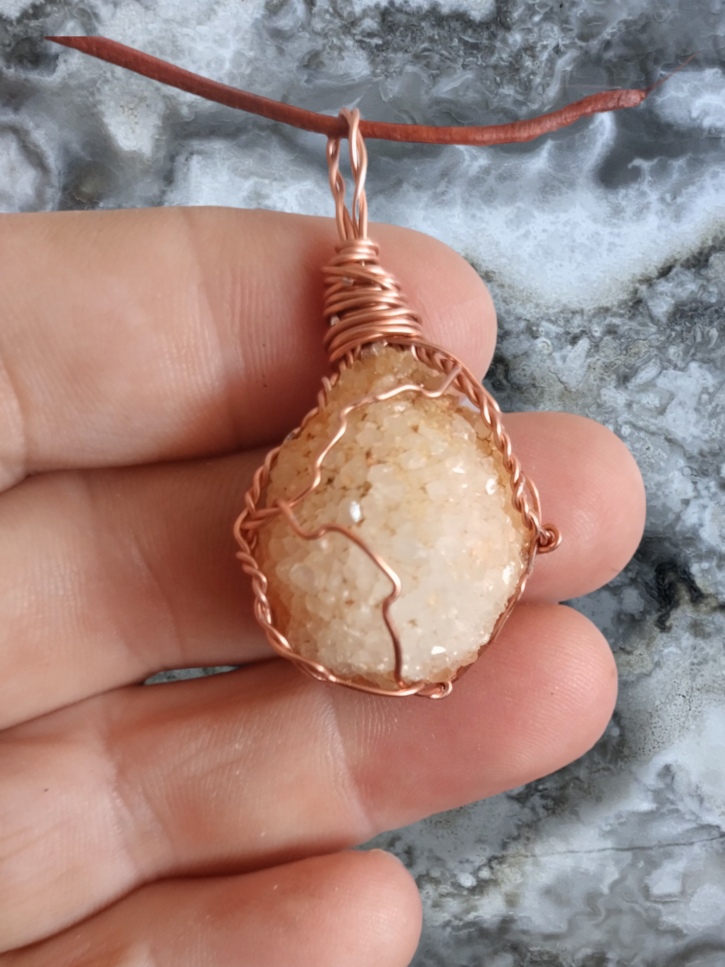 Druzy quartz hand wrapped pendant on an adjustable leather cord necklace.