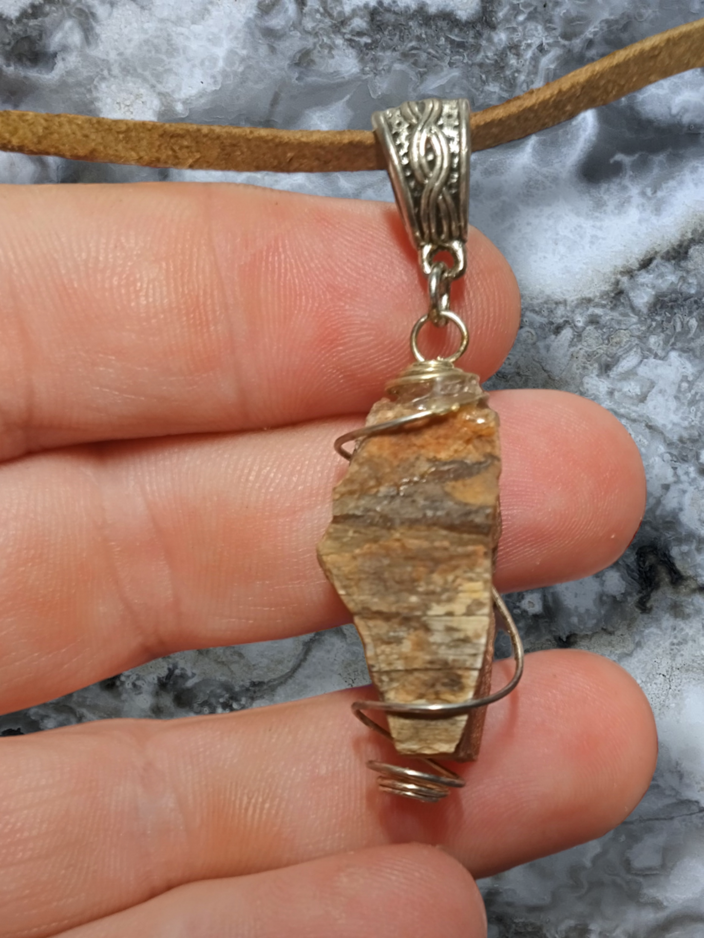 Petrified wood hand wrapped pendant on an adjustable leather cord necklace.