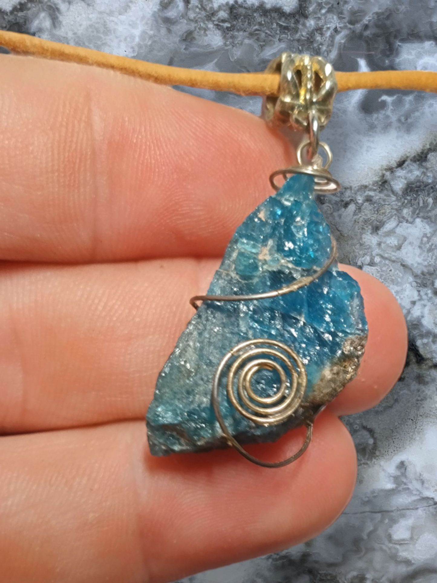 Apatite Crystal wrapped pendant on an adjustable leather cord necklace.
