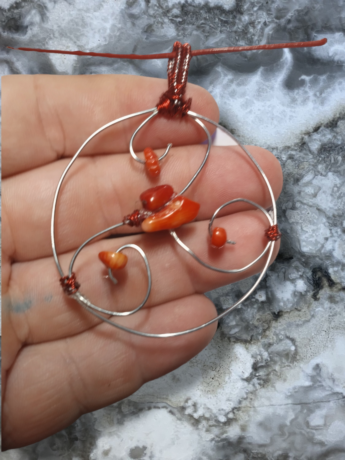 Red coral wired wrapped pendant on an adjustable leather cord necklace.