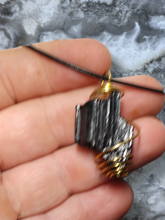 Black tourmaline pendant on an adjustable leather cord necklace.