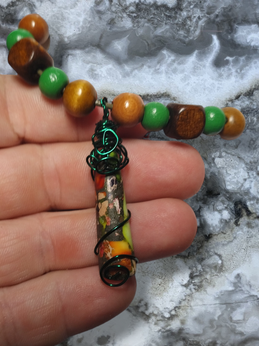 Hand wired wrapped pendant on an adjustable leather cord necklace.