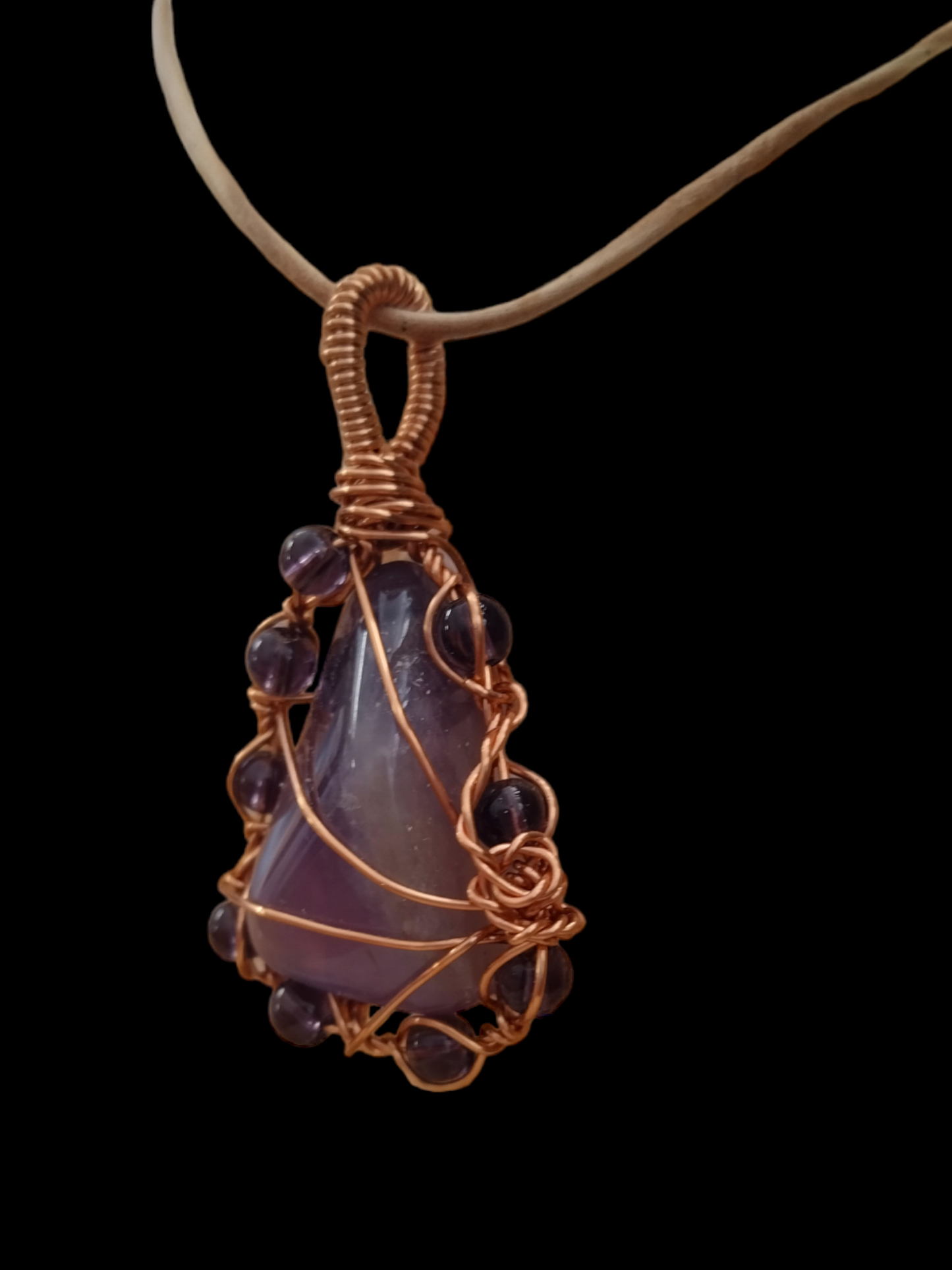 Handmade wired wrapped amethyst stone on an adjustable leather cord.