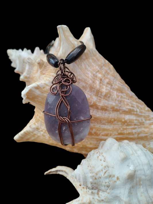 Handmade wired wrapped stone on an adjustable leather cord.