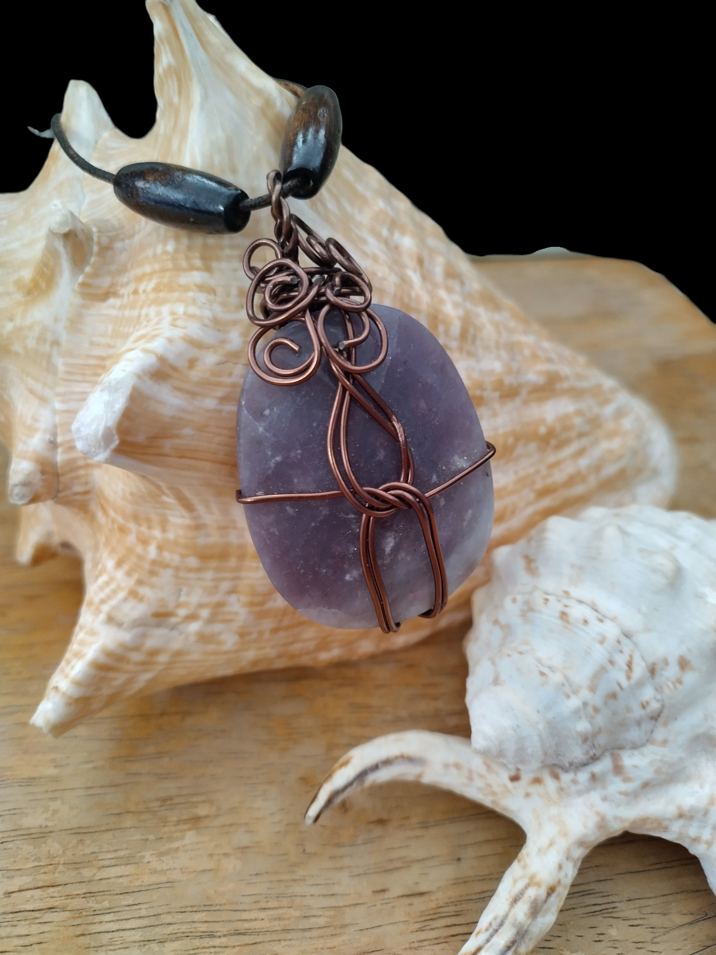 Handmade wired wrapped stone on an adjustable leather cord.