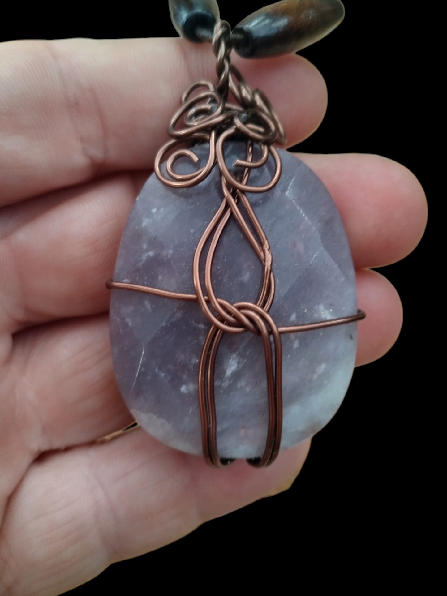 Handmade wired wrapped stone on an adjustable leather cord.