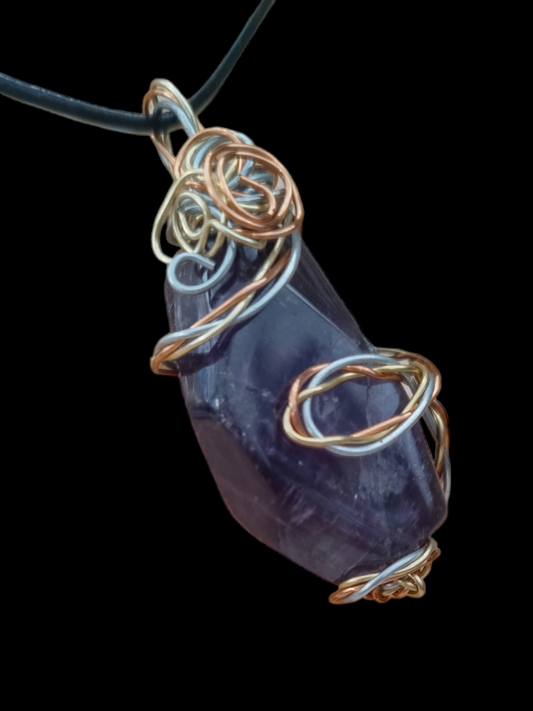 Handmade wired wrapped amethyst stone on an adjustable leather cord.