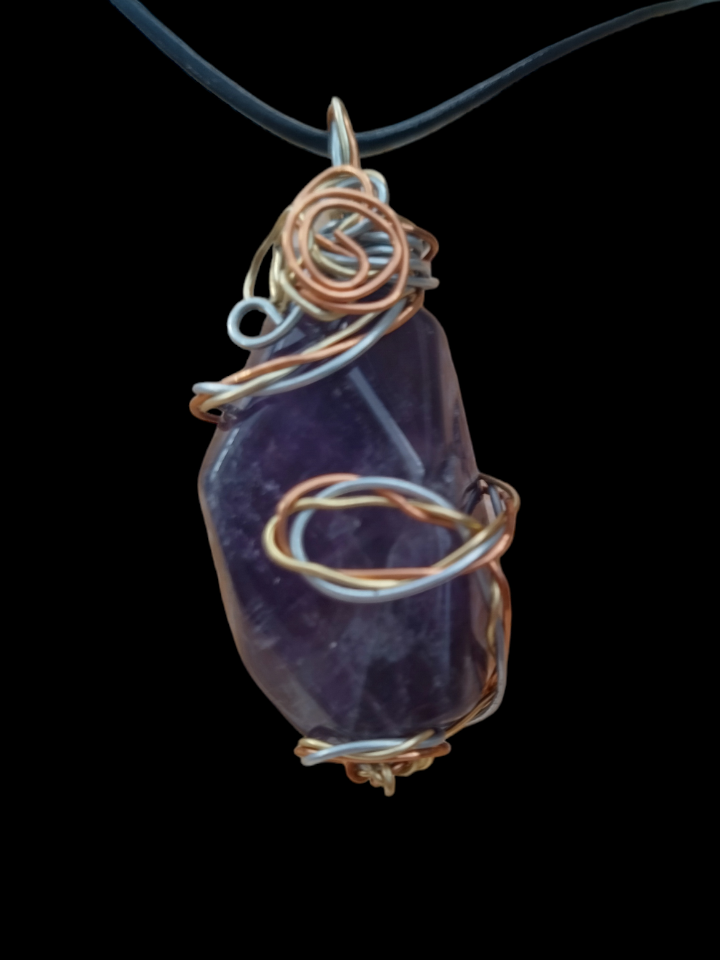 Handmade wired wrapped amethyst stone on an adjustable leather cord.