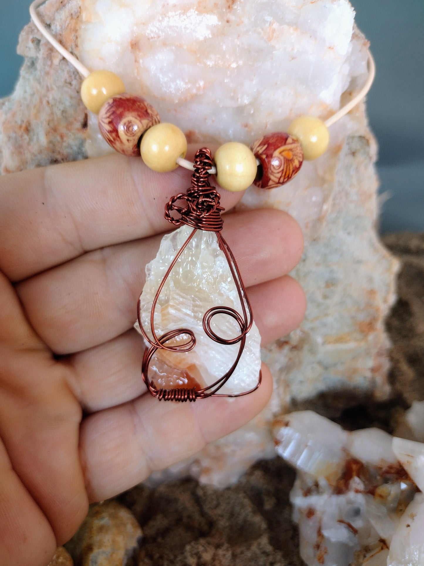 Necklace with wire wrapped tri color calcite pendant