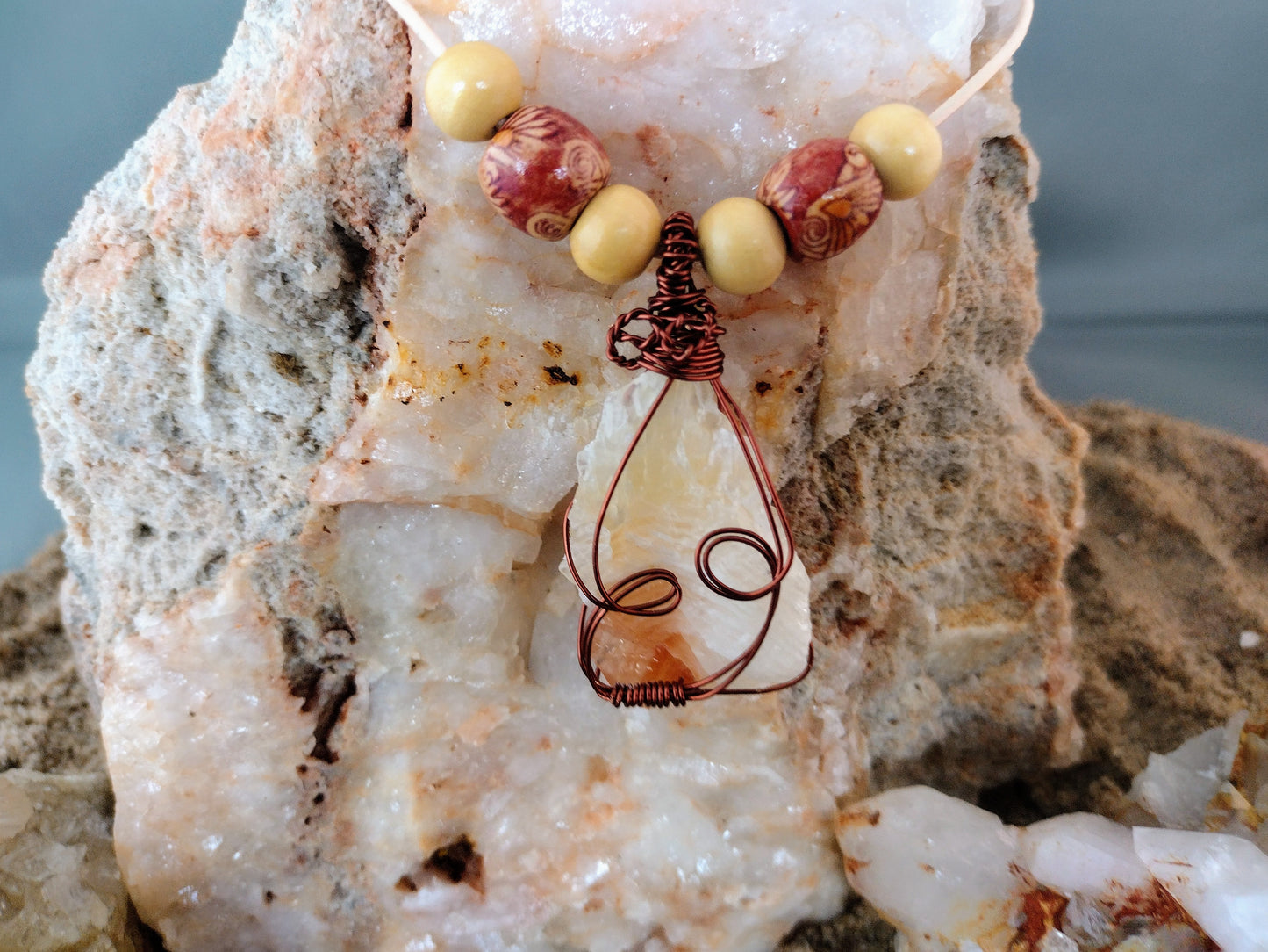Necklace with wire wrapped tri color calcite pendant